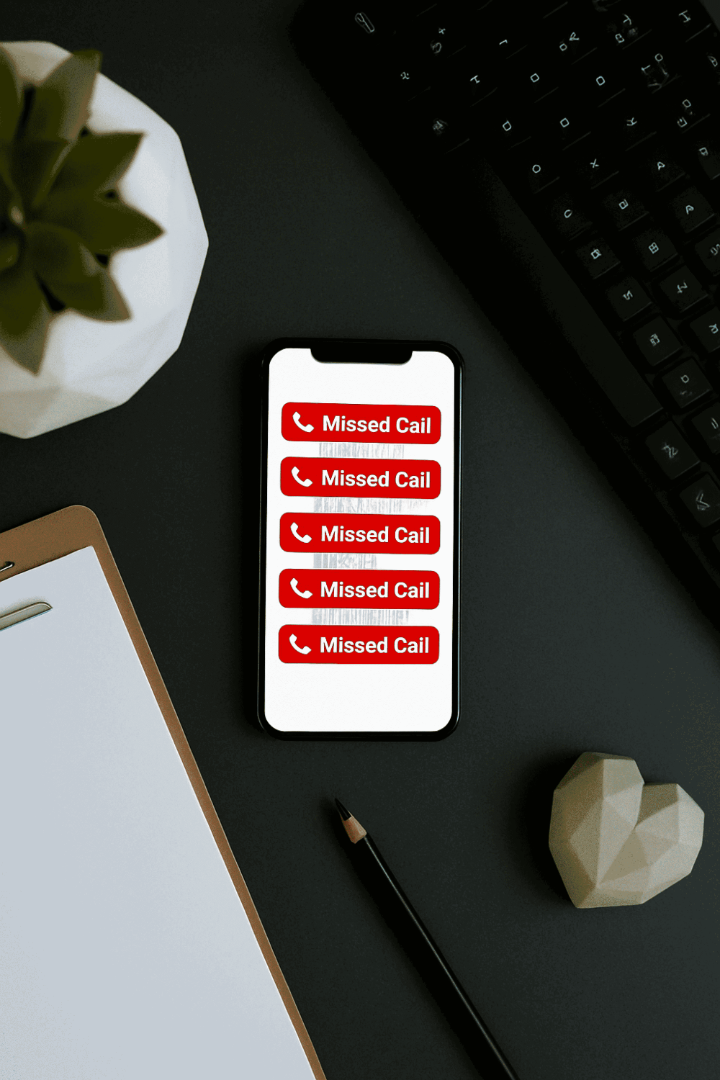 A smartphone screen displaying multiple missed call notifications on an office desk, illustrating lost business leads.